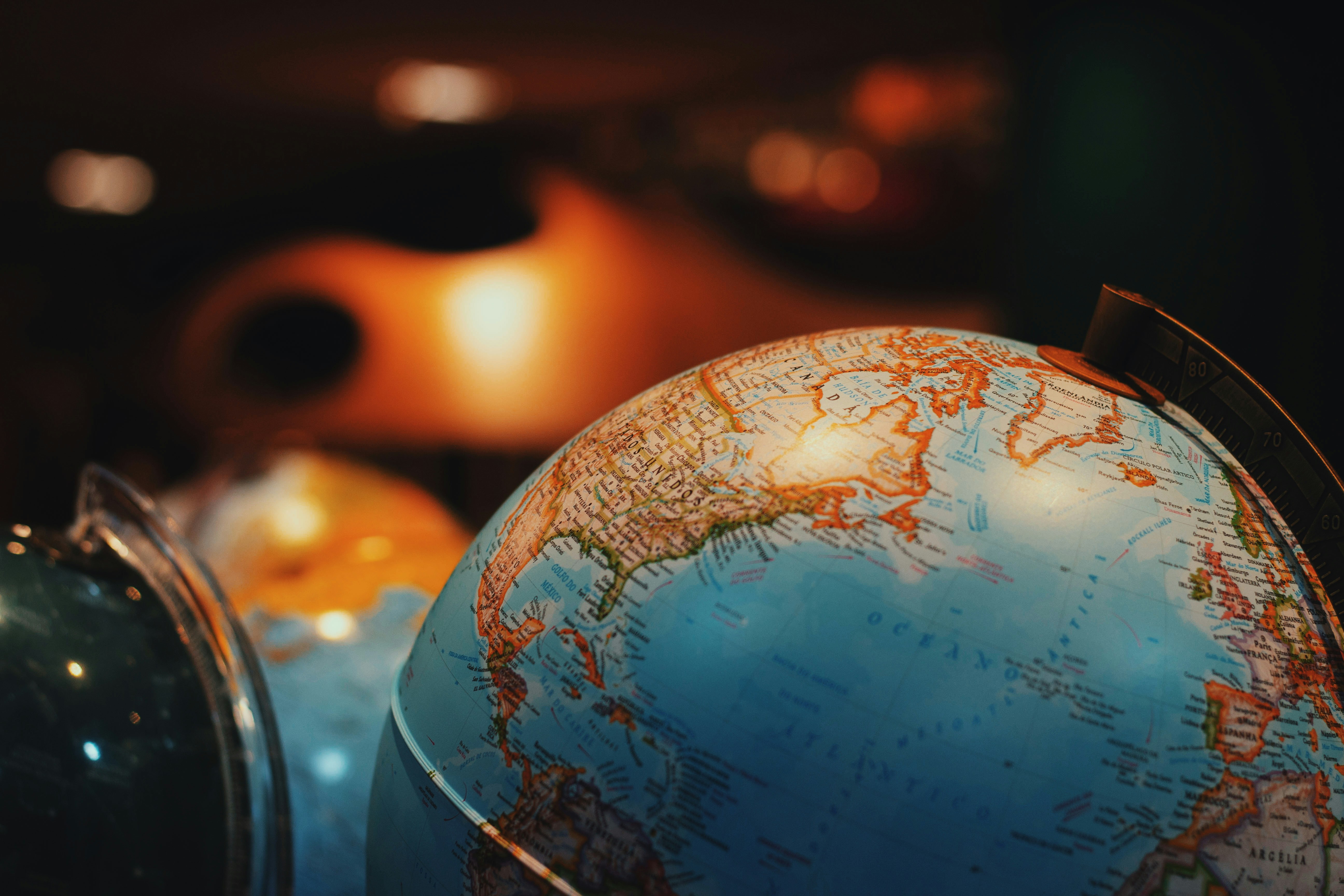 Close-up of an illuminated vintage globe showing North America in warm light